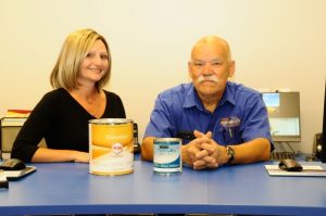 Friendly employees behind the counter selling refinishing paint.
